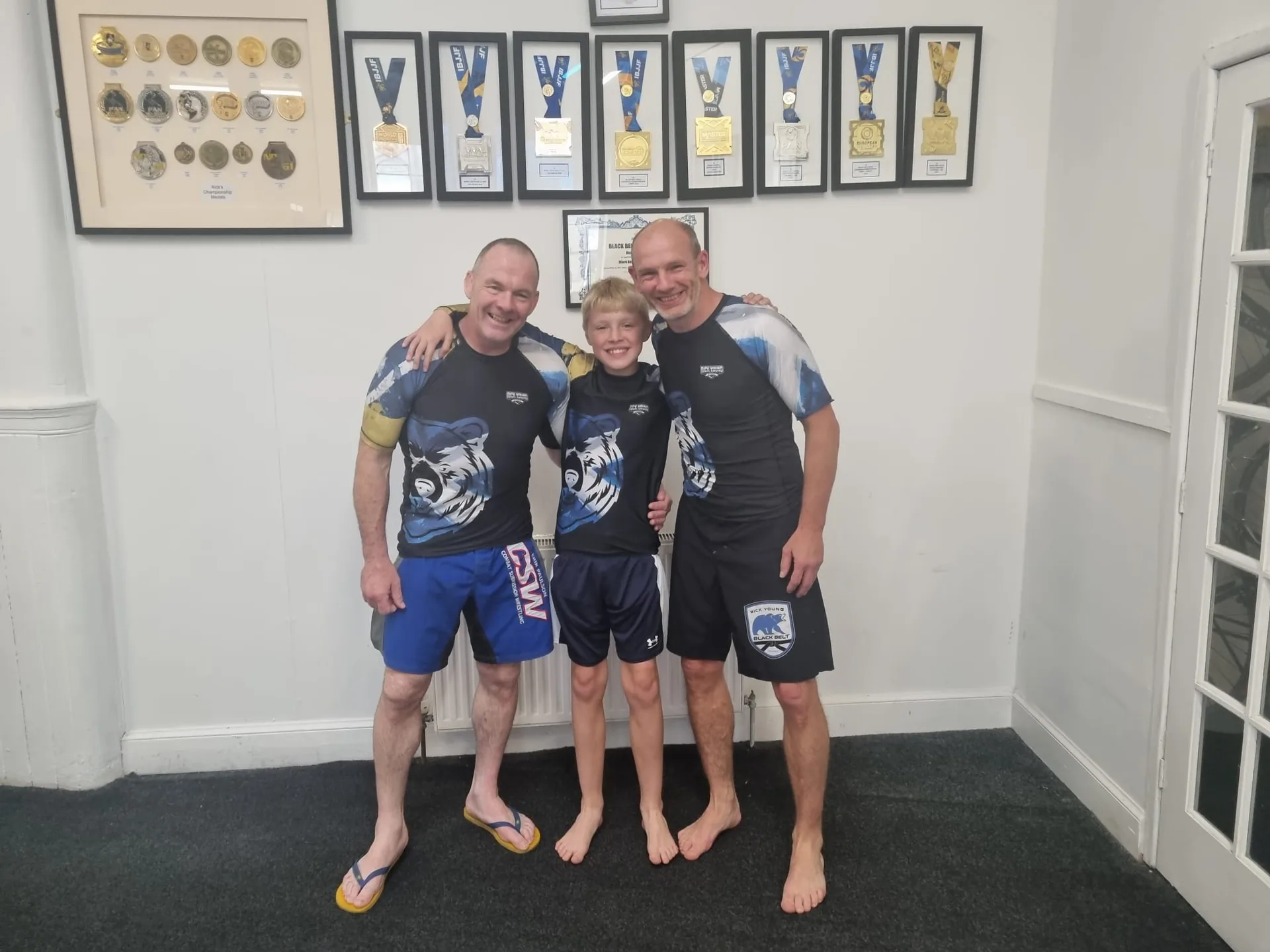 John McKean with fellow coaches and a young martial arts student
